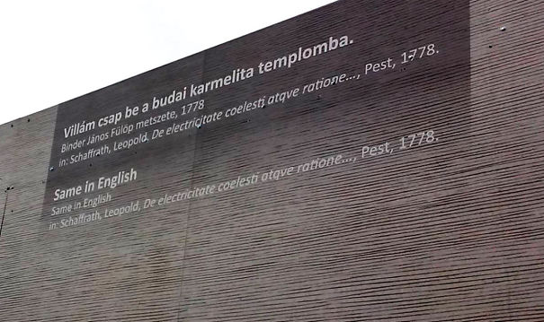 Text on a wooden wall with Hungarian and English translation error, illustrating a job fail.