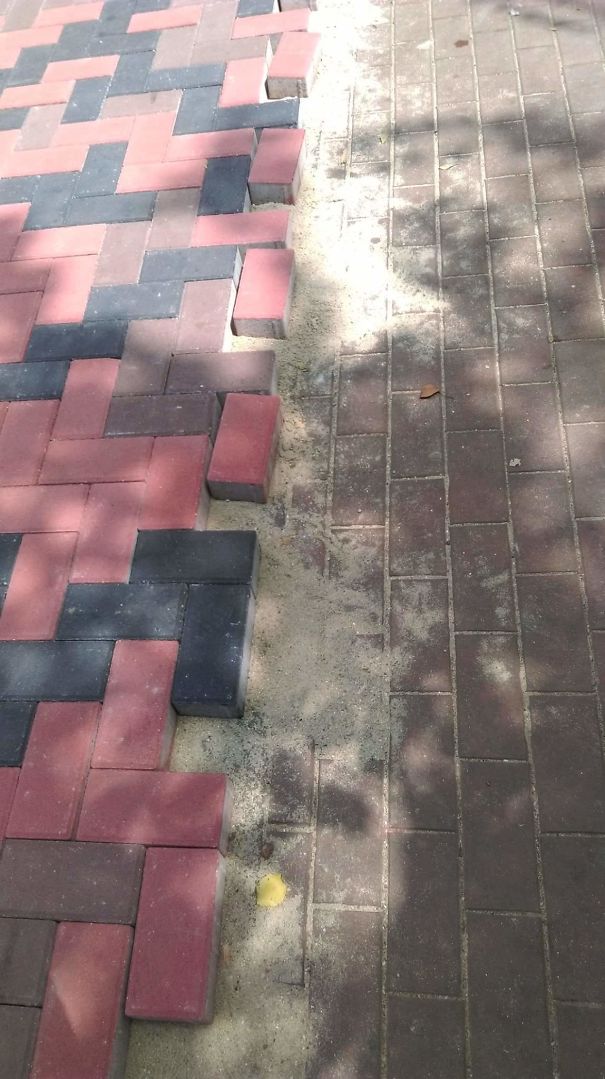 Misaligned paver installation with uneven edges and gaps, showcasing a paving job fail.