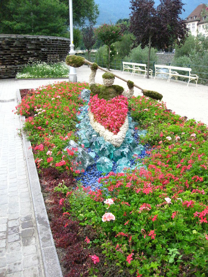 Man In Canoe, Made Of Flowers, Moss And Lichens. Merano, Italy