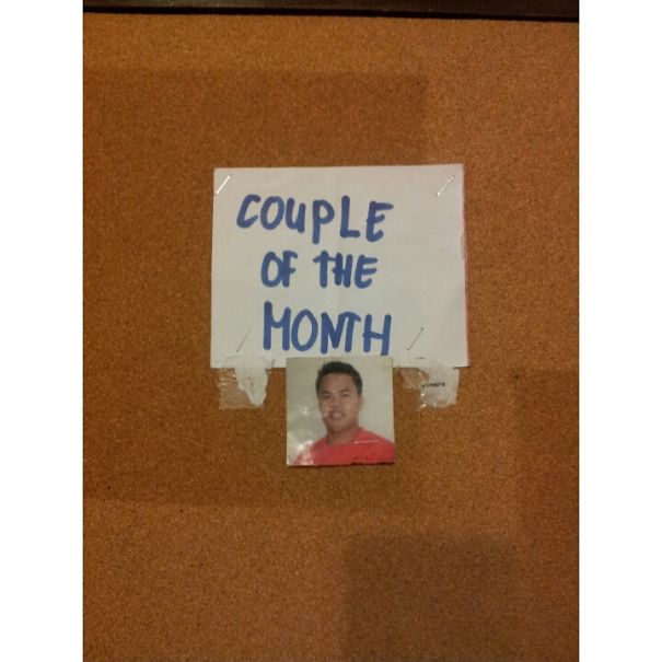 Photo of a single man under a sign reading "Couple of the Month," illustrating an amusing job fail.