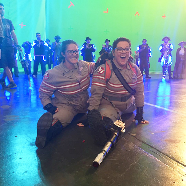 Two women dressed as Ghostbusters on a film set illustrating Hollywood celebrities’ body doubles in action.