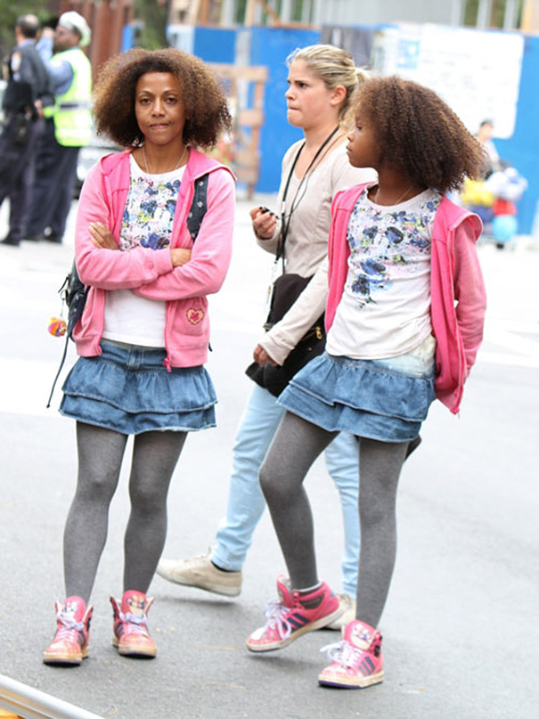 Two women wearing matching outfits standing on a city street, illustrating Hollywood celebrities’ body doubles concept.
