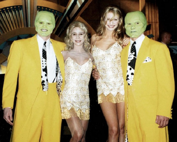 Two men in yellow suits and green masks stand with two women in matching dresses, showcasing celebrity body doubles in Hollywood.