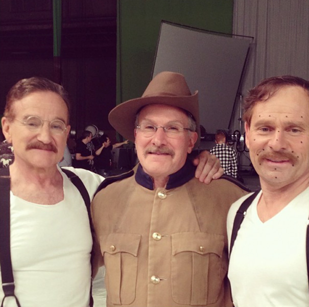 Three men posing on set, showcasing Hollywood celebrities body doubles in costume and makeup for filming.