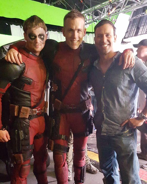 Three men on a film set with two wearing red superhero costumes, illustrating Hollywood celebrity body doubles.