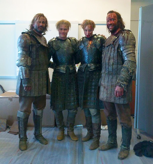 Four actors dressed in medieval armor on set, illustrating Hollywood celebrities’ body doubles in costume.