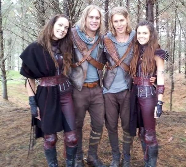 Four people dressed in fantasy costumes posing in a forest, illustrating Hollywood celebrities’ body doubles concept.