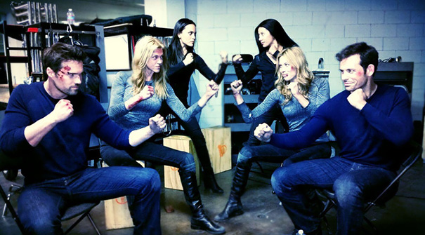 Two pairs of celebrities and their body doubles practicing fight scenes in a studio showcasing Hollywood body doubles.