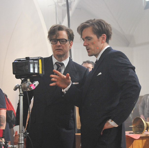 Two men in suits reviewing footage on a camera monitor, illustrating Hollywood celebrities body doubles on set.