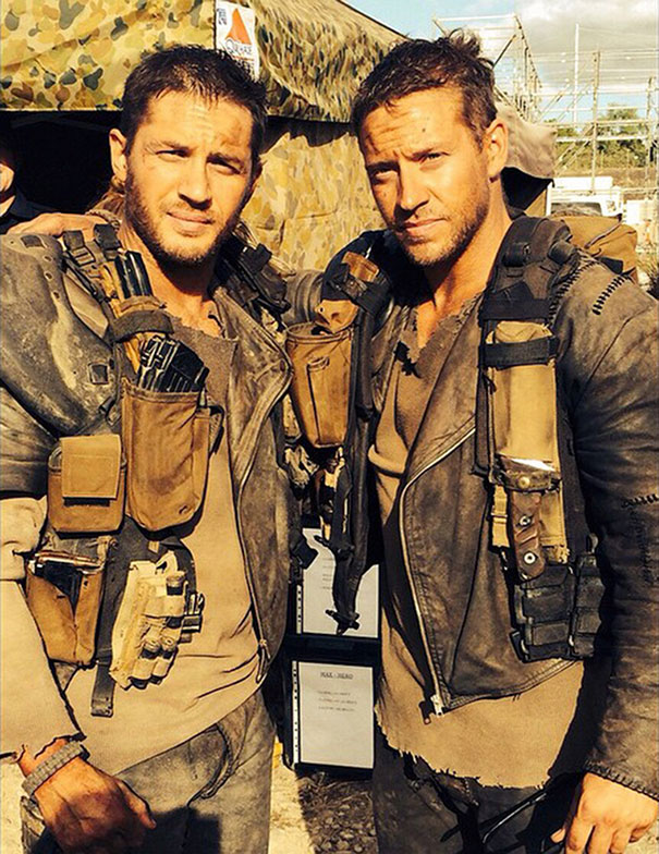 Two men in rugged military gear posing together as celebrity body doubles on a film set in Hollywood.