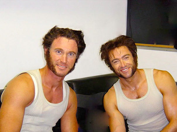 Two men wearing white tank tops with sideburns and similar hairstyles posing together as celebrity body doubles in Hollywood.