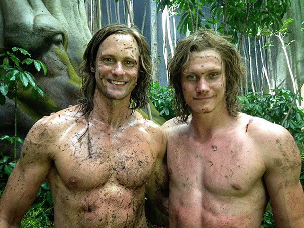 Two shirtless men covered in dirt posing together in a forest scene, highlighting Hollywood celebrities’ body doubles.