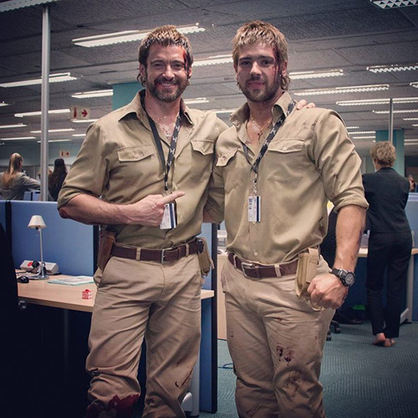 Two men dressed similarly in khaki shirts and pants, posing together as Hollywood celebrity body doubles on set.