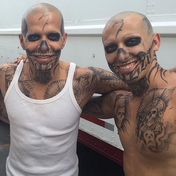 Two men with full body tattoos and skull face paint posing together, showcasing celebrity body doubles in Hollywood.