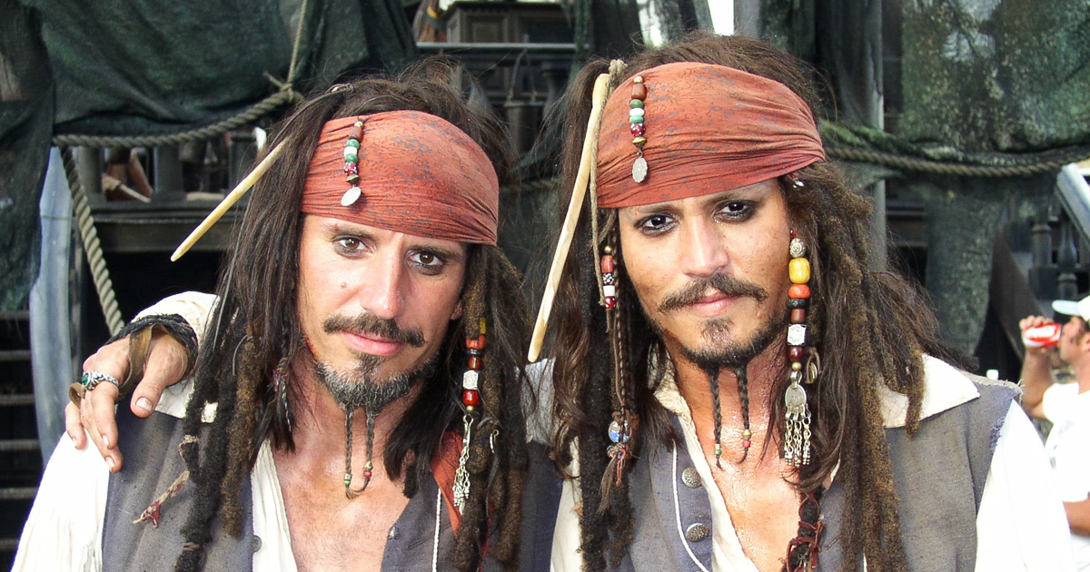 Two men dressed as pirates with bandanas and beaded dreadlocks showing body doubles in Hollywood films