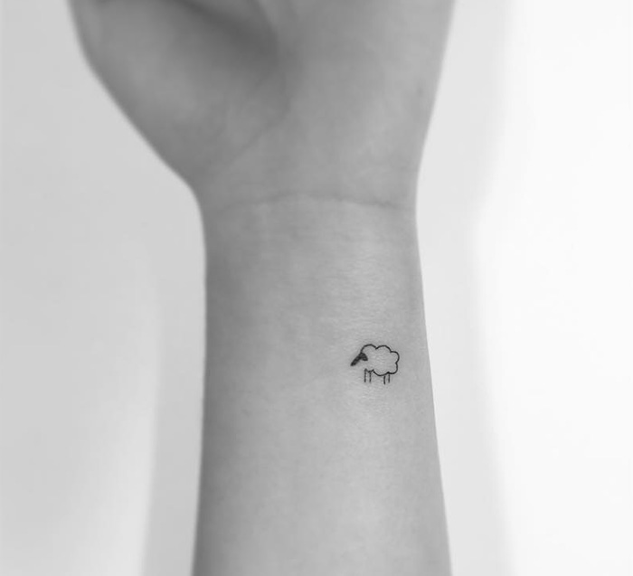 Minimalist tattoo of a small cloud on a forearm by a Korean artist.