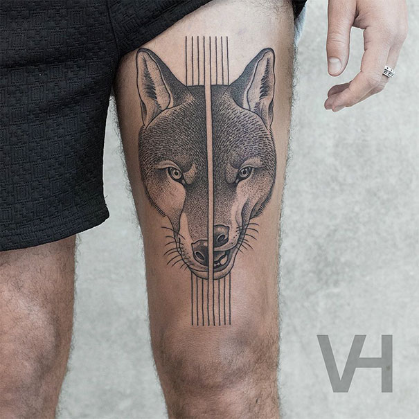 Symmetrical tattoo by Valentin Hirsch, featuring a wolf that combines nature and geometry on a person's thigh.