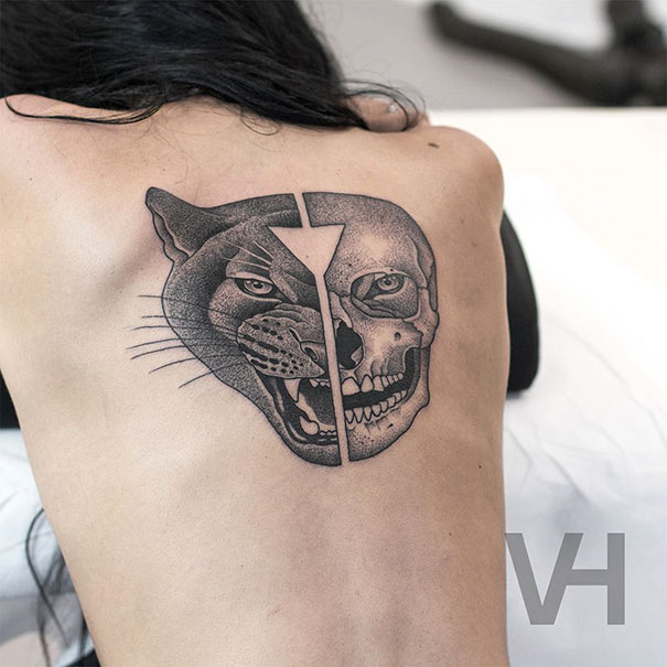 Symmetrical tattoo by Valentin Hirsch on a back, featuring a split design of a wolf and a skull blending nature and geometry.