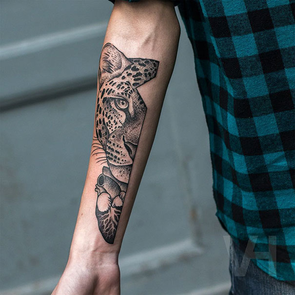 Symmetrical tattoo by Valentin Hirsch on forearm, blending nature and geometry with a leopard design.