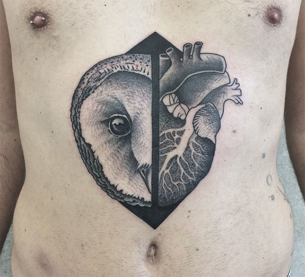 Symmetrical tattoo blending owl and heart designs, showcasing balance of nature and geometry.