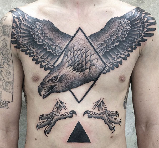 Symmetrical tattoo by Valentin Hirsch featuring an eagle blending nature and geometry on a person's chest.