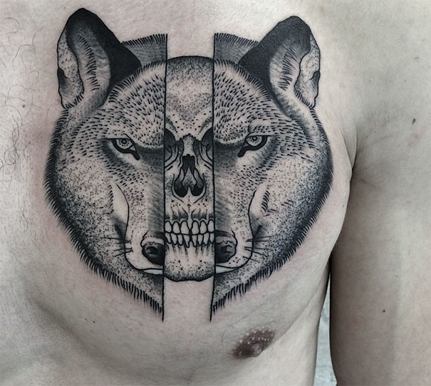 Symmetrical wolf tattoo on chest blends nature and geometry with a skull design in the center.