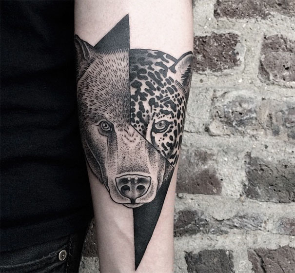 Symmetrical tattoo featuring a bear and leopard design, blending nature and geometry on a forearm.