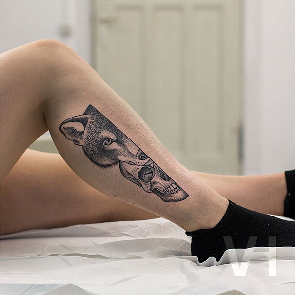 Symmetrical tattoo by Valentin Hirsch featuring a wolf and skull on a person's leg, blending nature and geometry.