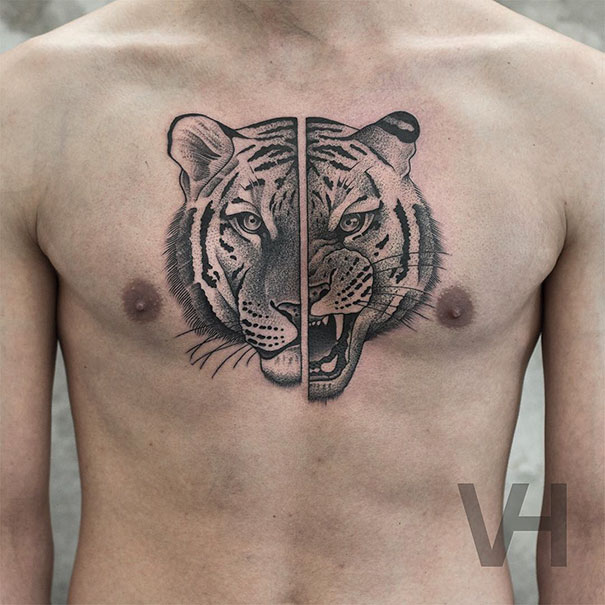 Symmetrical tattoo of a tiger on a man's chest, blending nature and geometry with striking detail.