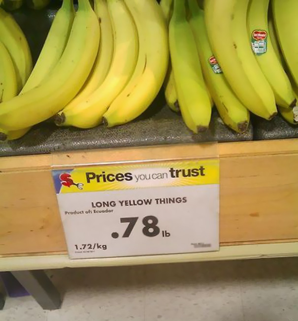 Store sign labeled "Long Yellow Things" above bananas, highlighting a humorous labeling fail.