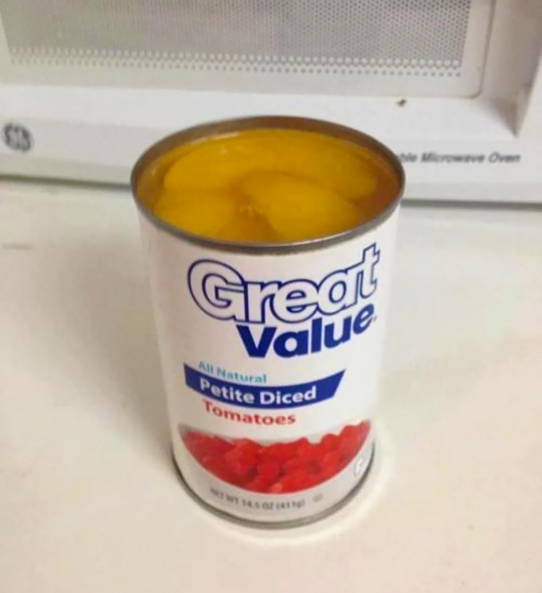 Can labeled as diced tomatoes filled with peach slices, illustrating a job fail.