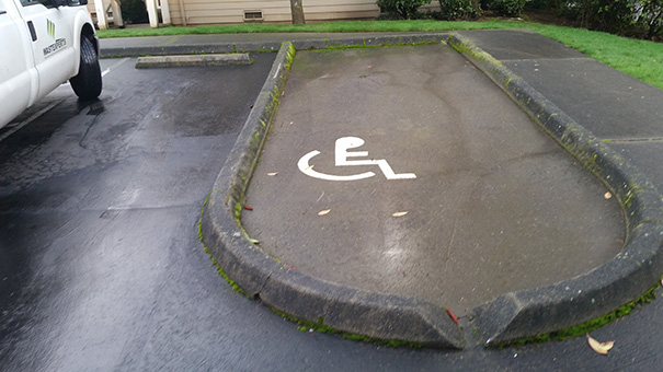 Failed job: Misaligned handicap parking spot with incorrect curb placement.
