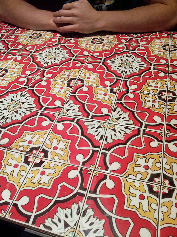 Misaligned patterned tiles on a table, exemplifying design failure.