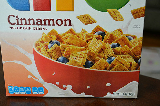 Cereal box showing a typo error; suggests cinnamon flavor but displays an unrelated cereal image.