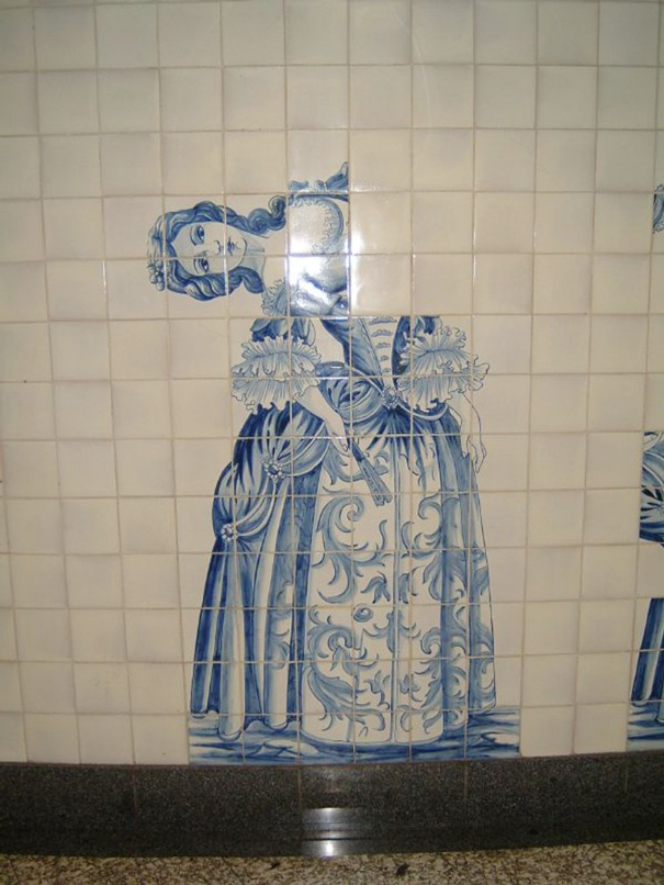 Tiled wall art misaligned, creating an amusing fail in decorative design.