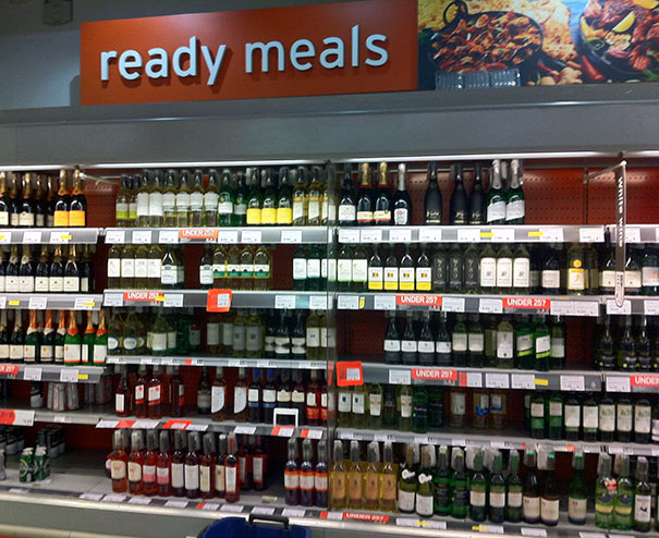 Supermarket display mislabeled as "ready meals," showing shelves of alcohol.