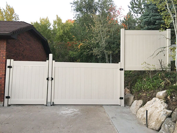 Misaligned white fence panels, illustrating a job failure.