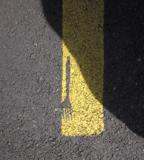 Fork shadow misaligned with yellow road line, illustrating a failed job attempt.
