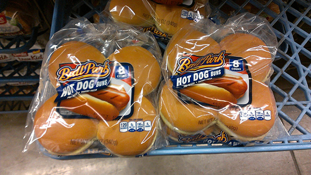 Packaging error with hot dog buns incorrectly inside hamburger bun bags in a grocery store.