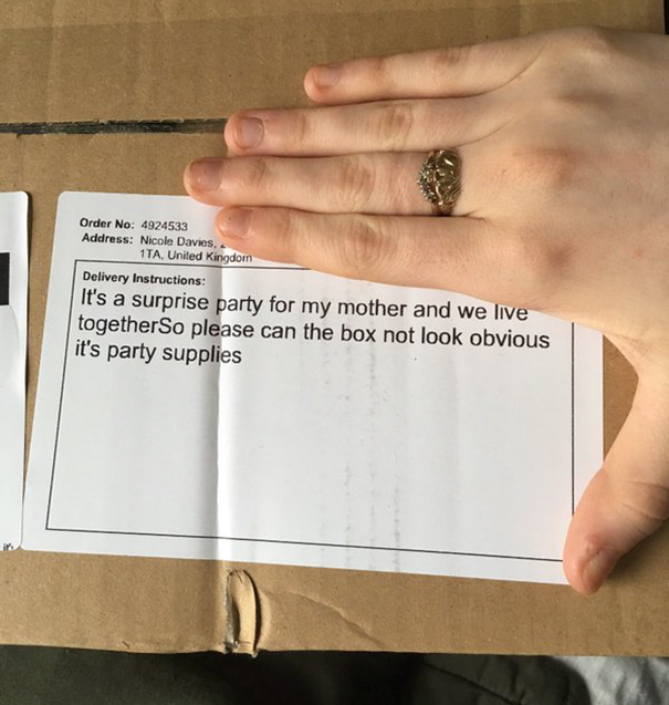 Delivery fail: package with instructions for surprise party visible, hand partially covering label on cardboard box.