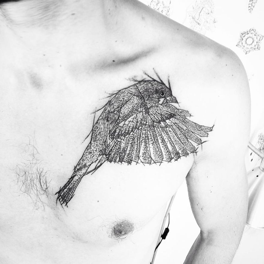 Sketchy tattoo of a bird on a person's chest, showcasing intricate line work and creative design.