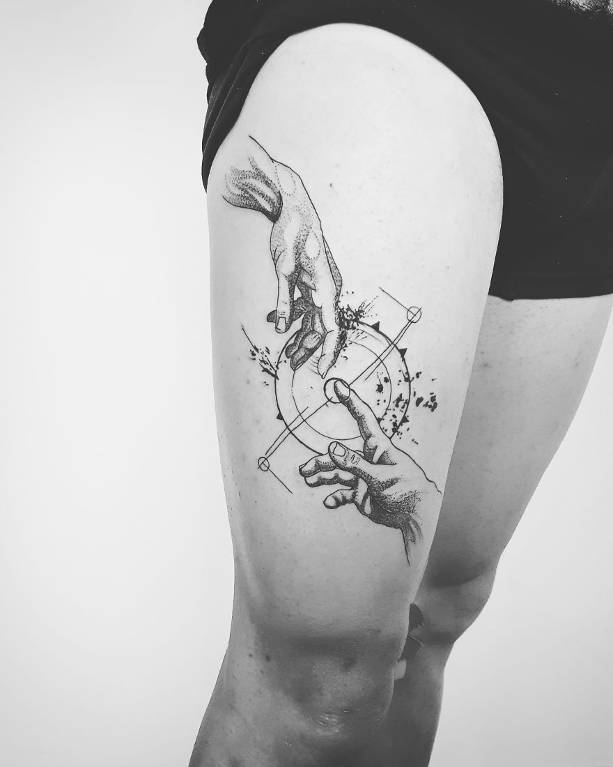 A sketchy tattoo of two hands reaching, inspired by Michelangelo, inked on a person's thigh.