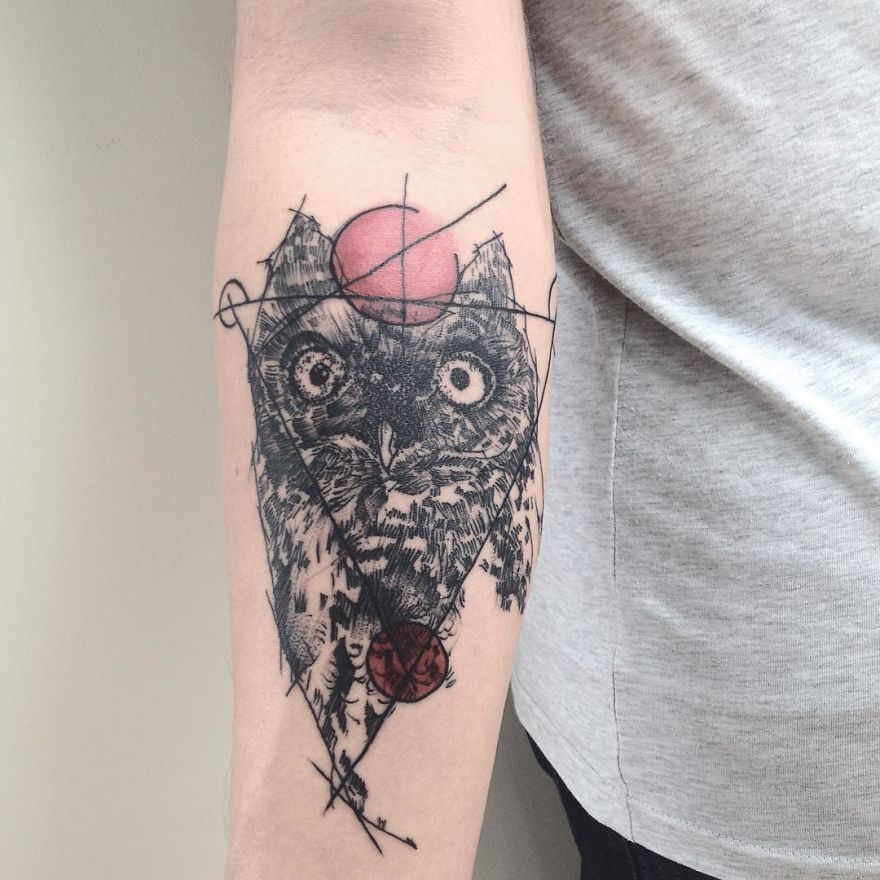 Sketchy tattoo of an owl with colorful circles on a person's arm.