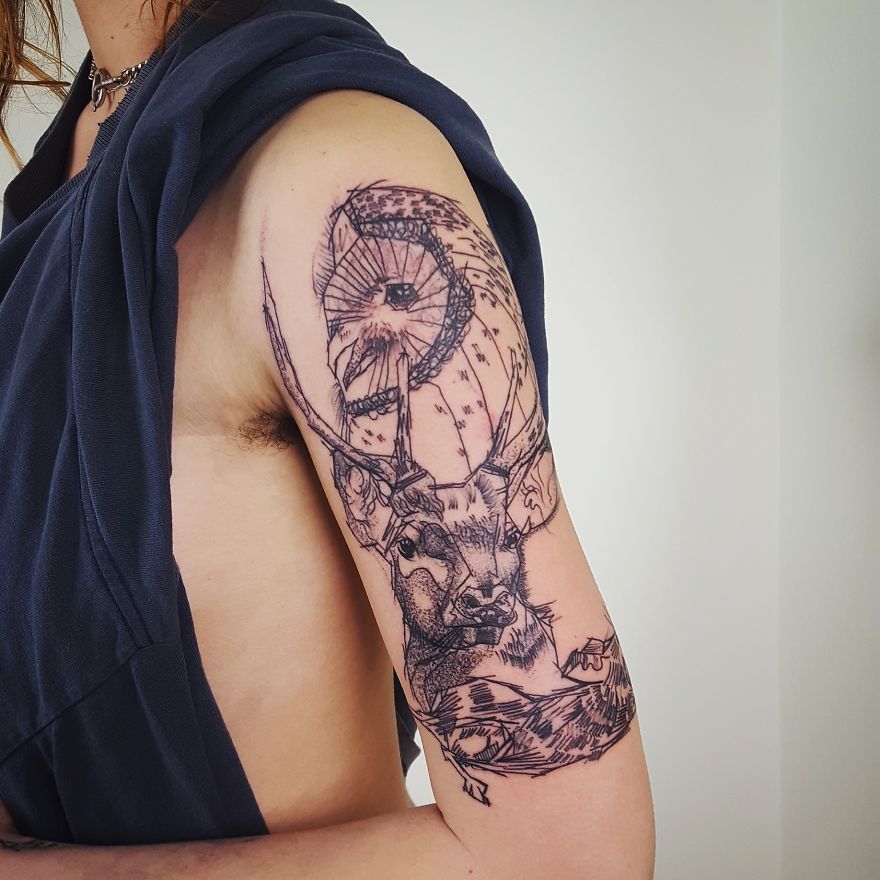 Sketchy tattoos featuring a detailed owl and deer design on an arm.