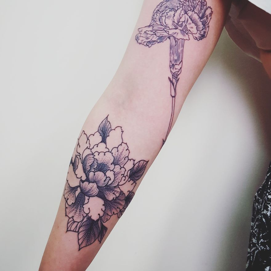 Sketchy floral tattoos by Vesna on an arm.