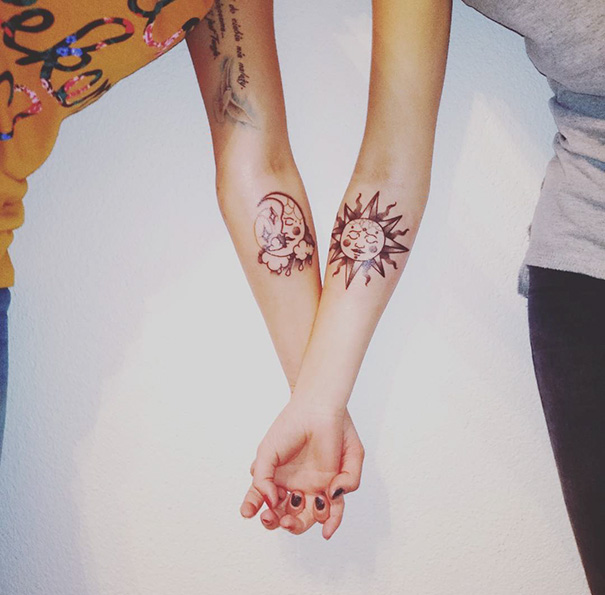 Trio tattoos featuring sun and moon designs on forearms, symbolizing harmony and connection between three friends.