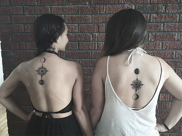 Two women showing trio tattoos on their backs, featuring celestial designs.