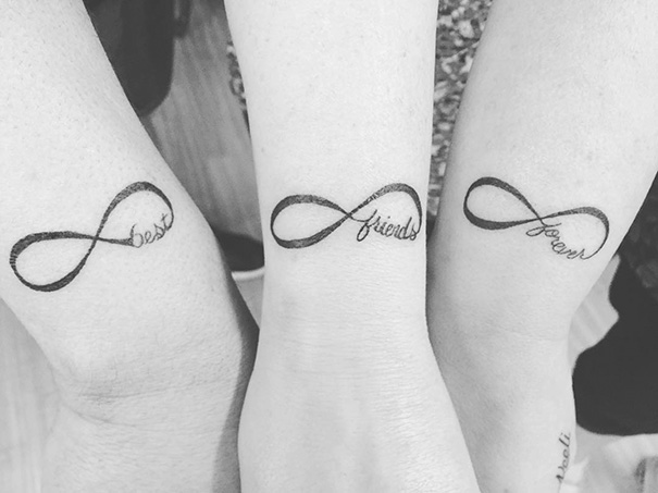 Three infinity tattoos on wrists with the words "best friends forever" representing trio tattoo ideas.