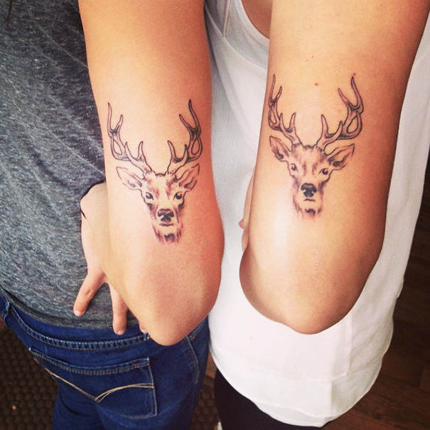 Matching trio tattoos of a stag head on two forearms, showcasing creative trio tattoos.