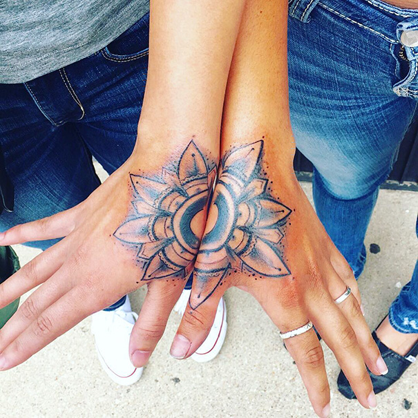 Three hands forming a complete geometric tattoo pattern, symbolizing trio tattoo ideas with a floral design.